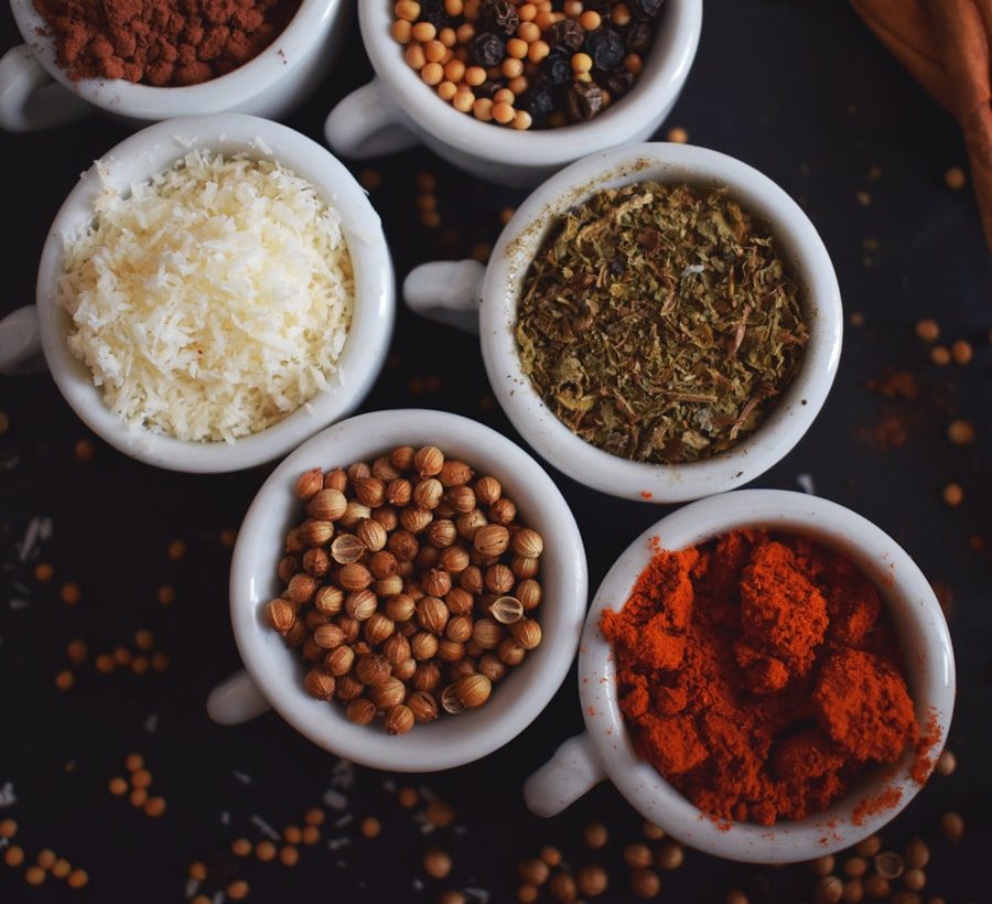 Assorted whole spices in white bowls